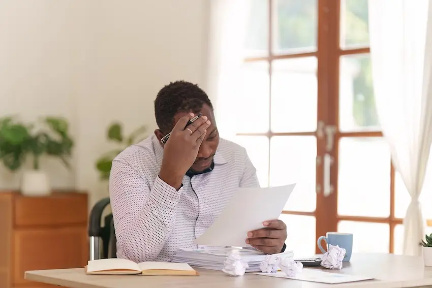 Car accident victim stressed about mounting hospital bills and potential lawsuit over unpaid medical debt