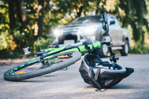 A helmet and bicycle after a crash represent an Atlanta bicycle accident lawyer case.